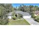 Aerial view of a single-Gathering home with a gray roof and a two-car garage at 17080 Kellog Ave, Port Charlotte, FL 33954