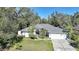 An aerial view of a charming house with a gray roof and landscaping at 17080 Kellog Ave, Port Charlotte, FL 33954