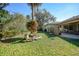 Landscaped backyard with rock garden and view of patio at 17080 Kellog Ave, Port Charlotte, FL 33954