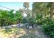 Relaxing backyard patio with seating area and lush landscaping at 17080 Kellog Ave, Port Charlotte, FL 33954