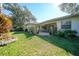 Spacious backyard with patio, lush landscaping, and wooden fence at 17080 Kellog Ave, Port Charlotte, FL 33954