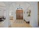 Bright entryway with double doors and a chandelier at 17080 Kellog Ave, Port Charlotte, FL 33954
