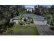 Single-story house with gray roof, white exterior, and a two-car garage at dusk at 17080 Kellog Ave, Port Charlotte, FL 33954