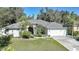Single-story home with gray roof, white exterior, and a two-car garage at 17080 Kellog Ave, Port Charlotte, FL 33954