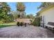 Brick paved patio with seating area and wooden privacy fence at 17080 Kellog Ave, Port Charlotte, FL 33954