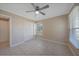 Bright bedroom with tile floors, window, and double door closet at 2030 Basin St, Port Charlotte, FL 33952