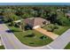 Aerial view of single-story house with a large yard, driveway, and palm trees at 21561 Quesada Ave, Port Charlotte, FL 33952