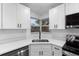 Bright kitchen with white cabinetry, stainless steel appliances, and a window over the sink offering a pleasant view at 22266 Catherine Ave, Port Charlotte, FL 33952