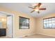 Bright bedroom with ceiling fan, light flooring, and two windows at 22442 Olean Blvd, Port Charlotte, FL 33952