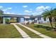 Light blue home exterior, featuring a carport and white fence at 22442 Olean Blvd, Port Charlotte, FL 33952