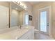 Bathroom with single vanity, white cabinets, and exterior access at 3736 Bal Harbor Blvd, Punta Gorda, FL 33950