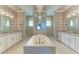 Elegant bathroom with double vanity, large soaking tub, and chandelier at 3736 Bal Harbor Blvd, Punta Gorda, FL 33950