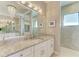 Spa-like bathroom featuring double sinks, granite counters, and a chandelier at 3736 Bal Harbor Blvd, Punta Gorda, FL 33950