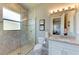 Modern bathroom with a walk-in shower and granite vanity at 3736 Bal Harbor Blvd, Punta Gorda, FL 33950