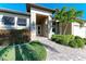 Front entry with walkway, landscaping, and shutters at 3736 Bal Harbor Blvd, Punta Gorda, FL 33950