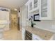 Elegant wet bar with granite countertop and wine cooler at 3736 Bal Harbor Blvd, Punta Gorda, FL 33950