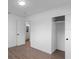 Clean bedroom with wood-look floors, with a bathroom and closet at 5344 Swaying Palm Dr, Punta Gorda, FL 33982