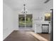 Dining area with sliding glass doors, white cabinets, stainless steel sink, and hardwood flooring at 5344 Swaying Palm Dr, Punta Gorda, FL 33982