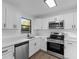 Bright kitchen featuring stainless steel appliances, and white cabinets with dark hardware at 5344 Swaying Palm Dr, Punta Gorda, FL 33982