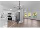 Modern kitchen with stainless steel appliances, white cabinetry, and an open floor plan at 5344 Swaying Palm Dr, Punta Gorda, FL 33982