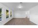 Bright living room with hardwood floors, plenty of natural light, and white walls at 5344 Swaying Palm Dr, Punta Gorda, FL 33982