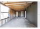 Unfinished room with exposed beams, concrete floors, and a single window at 5344 Swaying Palm Dr, Punta Gorda, FL 33982