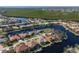 Bird's-eye view of a canal-front home with lush landscaping at 566 Port Bendres Dr, Punta Gorda, FL 33950