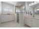 Elegant bathroom with double sinks, large shower, and ample storage at 566 Port Bendres Dr, Punta Gorda, FL 33950