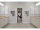 Spa-like bathroom with double vanities and a view into the bedroom at 566 Port Bendres Dr, Punta Gorda, FL 33950