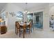 Bright dining room with wooden table and access to patio at 566 Port Bendres Dr, Punta Gorda, FL 33950