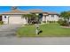 Attractive single-story home with a well-manicured lawn and attached garage at 566 Port Bendres Dr, Punta Gorda, FL 33950