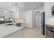 Modern kitchen with white cabinets, breakfast bar, and stainless steel appliances at 566 Port Bendres Dr, Punta Gorda, FL 33950