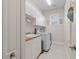 Laundry room with washer, dryer, cabinets, and utility sink at 566 Port Bendres Dr, Punta Gorda, FL 33950