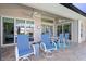 Covered patio with seating area, outdoor dining table, and ceiling fans at 566 Port Bendres Dr, Punta Gorda, FL 33950
