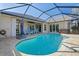Inviting swimming pool with screened enclosure and patio at 566 Port Bendres Dr, Punta Gorda, FL 33950