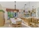 Bright dining room with a large table, wood hutch and window looking out to the backyard at 6405 Buckboard St, North Port, FL 34291