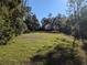 Spacious lot with mature trees and grassy areas at 6405 Buckboard St, North Port, FL 34291