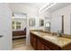 Bathroom with double sinks, granite countertop, and view of bedroom at 7177 W Lenox Cir, Punta Gorda, FL 33950