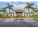 Community clubhouse with palm trees and ample parking at 7177 W Lenox Cir, Punta Gorda, FL 33950