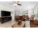 Open living area with sectional sofa, wood coffee table, and ceiling fan at 7177 W Lenox Cir, Punta Gorda, FL 33950