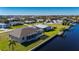 Aerial view of a waterfront home with a pool and dock at 740 Kingfish Ct, Punta Gorda, FL 33950