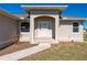 Front entryway with arched alcove, double doors, and landscaping at 740 Kingfish Ct, Punta Gorda, FL 33950