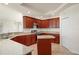 Kitchen boasts wood cabinets, granite countertops, and an island at 740 Kingfish Ct, Punta Gorda, FL 33950