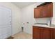 Laundry room with cabinets, sink, and exterior access at 740 Kingfish Ct, Punta Gorda, FL 33950