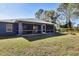 Home exterior with screened patio and grassy backyard at 7432 Meroni Blvd, North Port, FL 34291