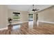 Large living room with hardwood floors and sliding glass doors at 7432 Meroni Blvd, North Port, FL 34291