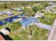 Aerial view of canal-front home with metal roof and shed at 824 E 6Th St, Englewood, FL 34223