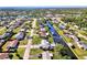 Aerial view of a house on a canal, surrounded by other homes at 824 E 6Th St, Englewood, FL 34223