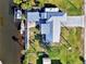 Drone shot of canal-front home showcasing metal roof and backyard at 824 E 6Th St, Englewood, FL 34223