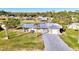 Aerial view of a single-story home with metal roof, driveway, and canal access at 824 E 6Th St, Englewood, FL 34223